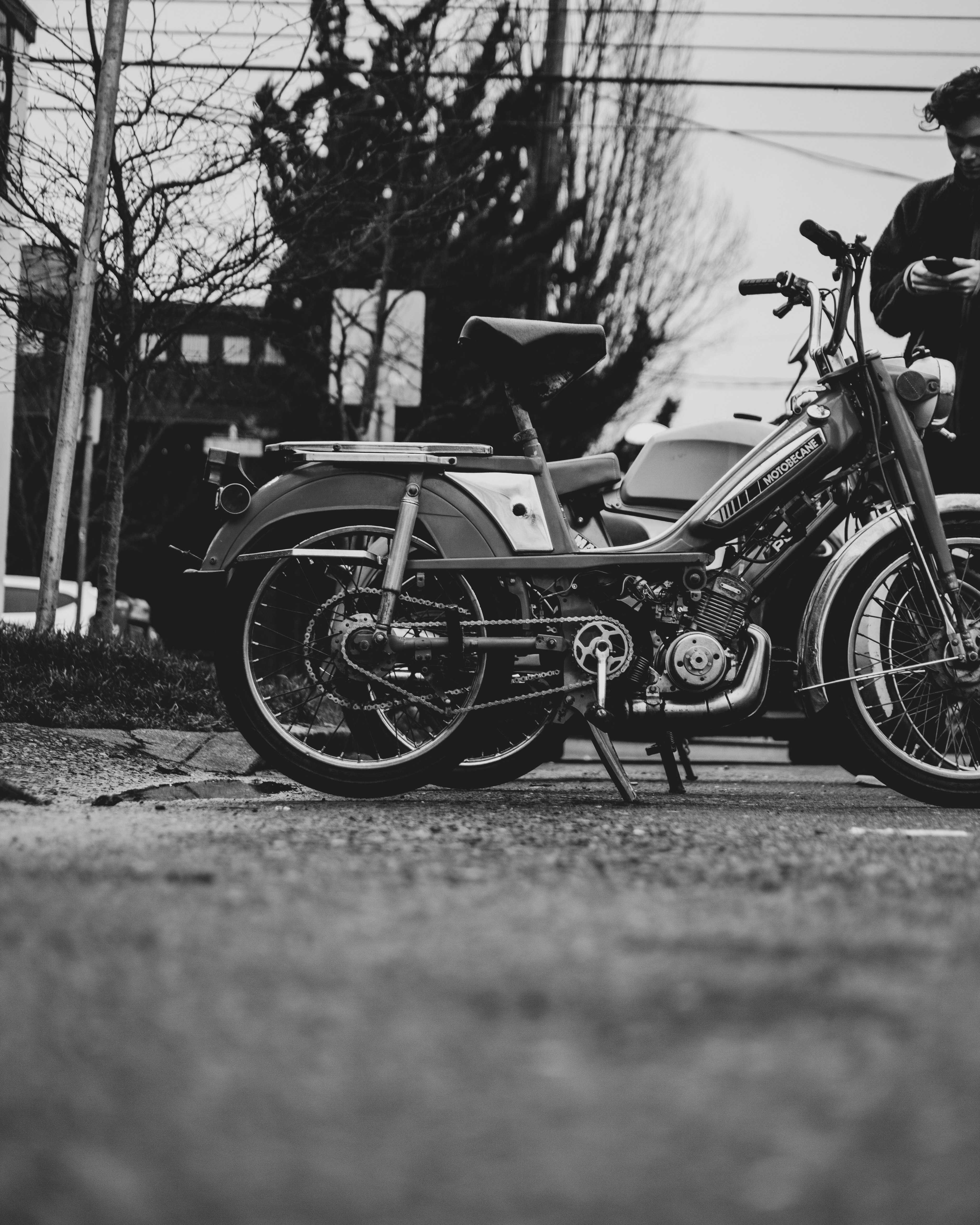 grayscale photo of motorcycle parked on road